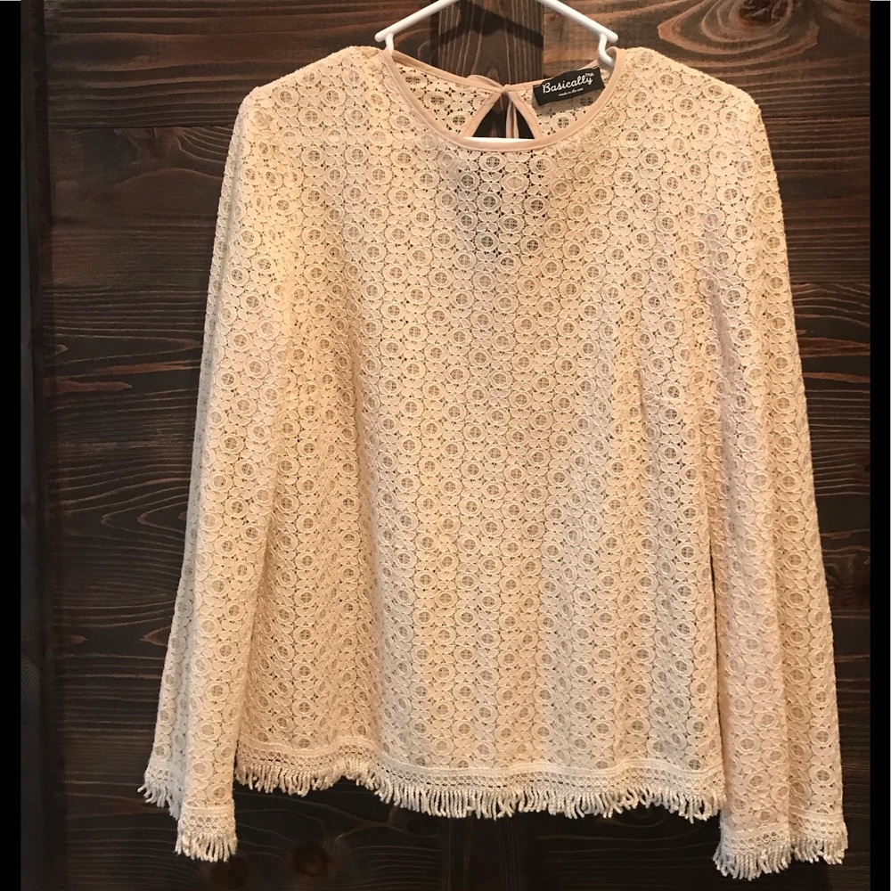 Cream elegant top with fringe detail.